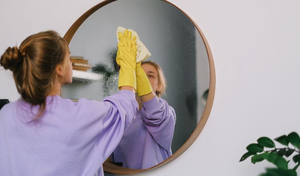 woman deep cleaning her home before her Christmas party
