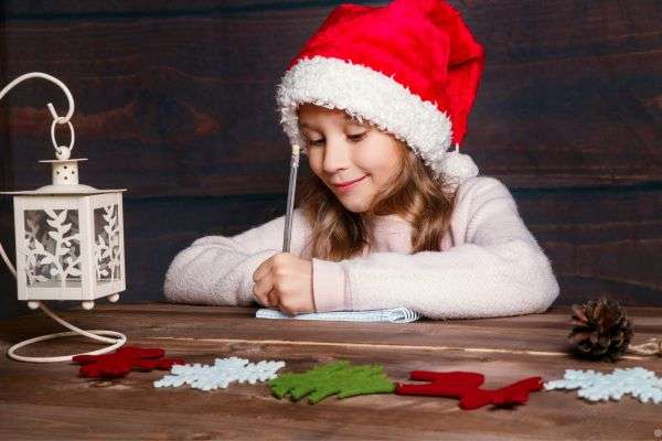 little girl writing a letter to santa